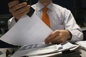 Businessman Stapling Documents --- Image by © Todd Warnock/Corbis